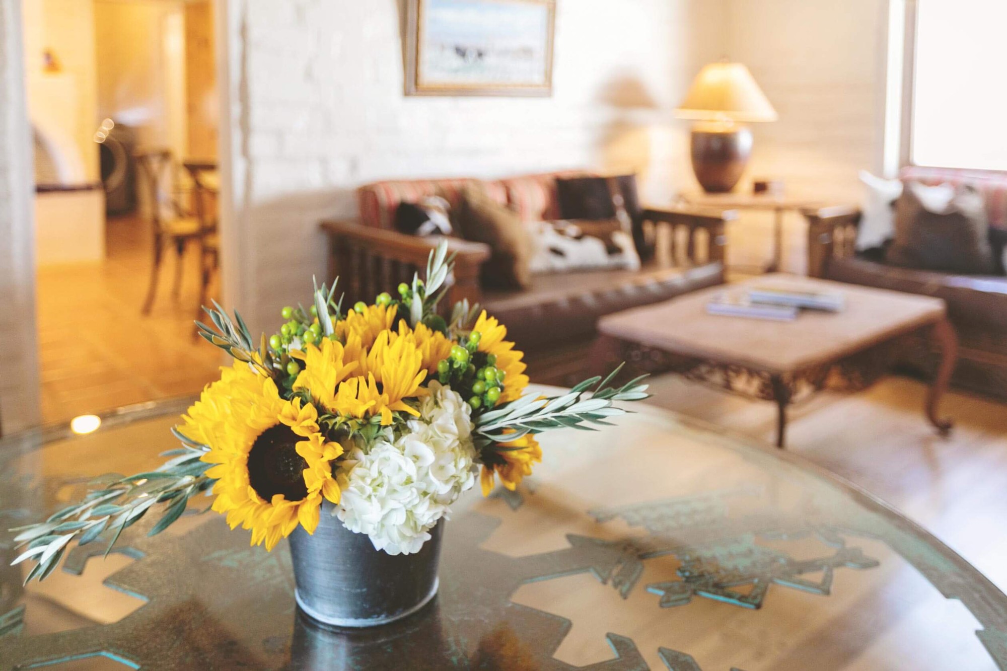 Sunflowers on a table in a mission-style living room.