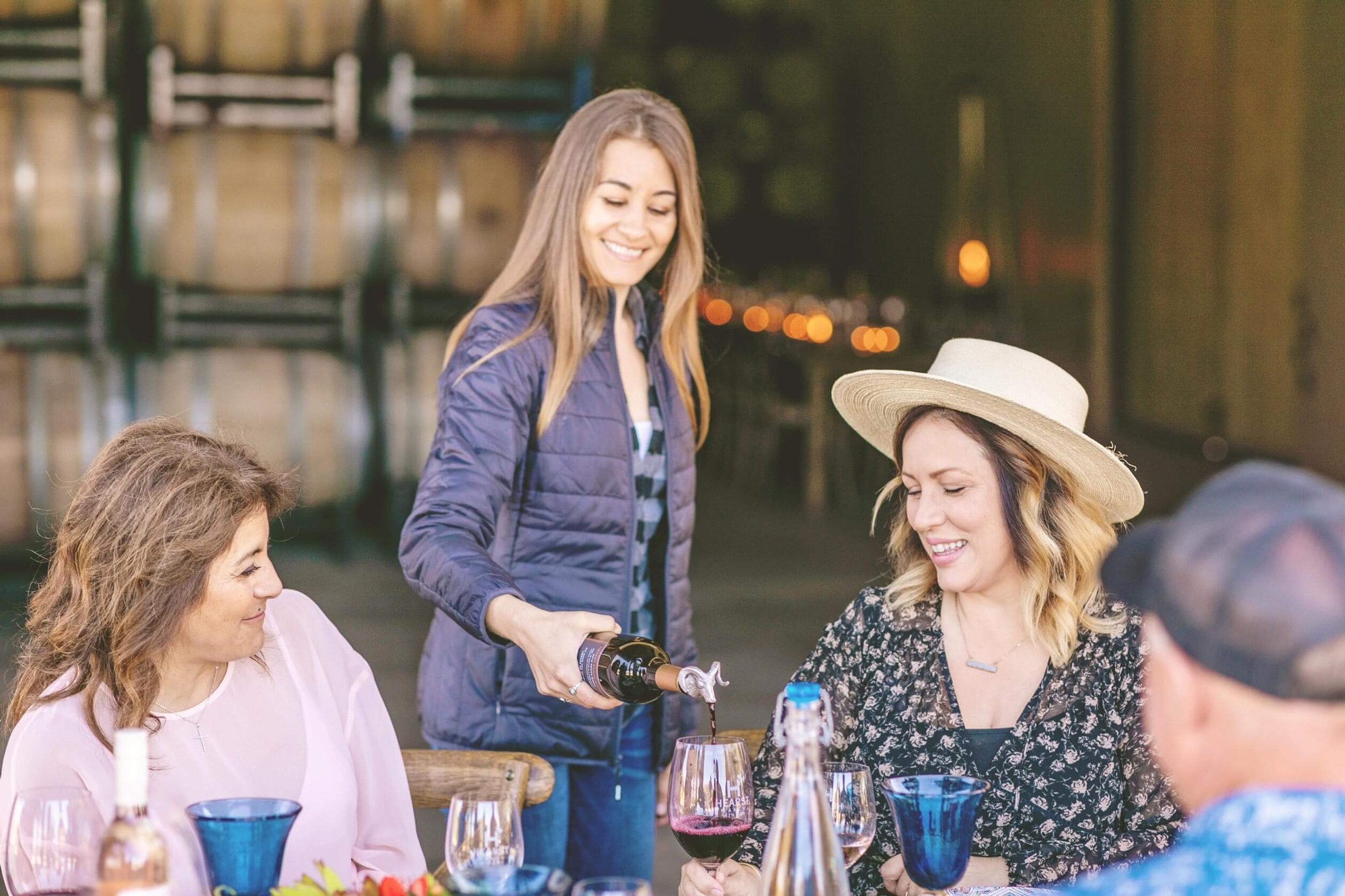 Woman pouring wine for friends.